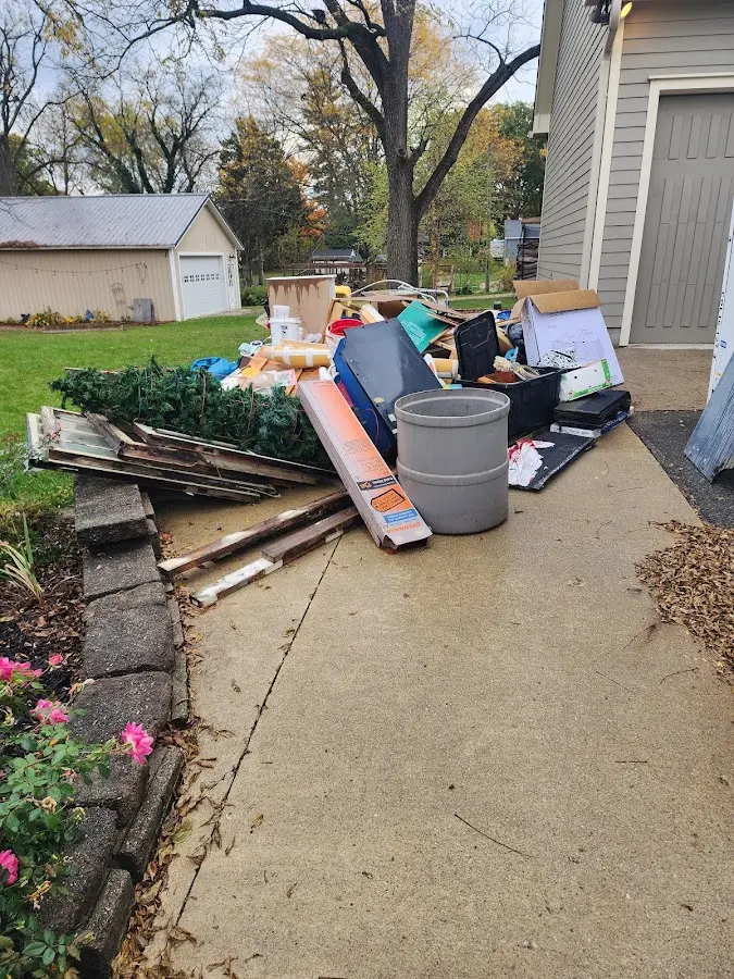 Dumpster being loaded with debris for Estate Cleanout Dumpster Rental in Box Elder